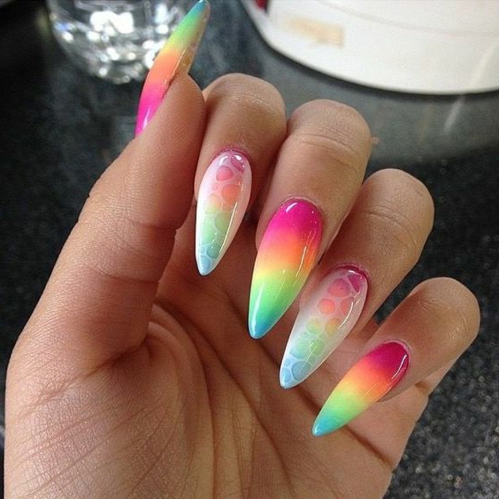 long stiletto acrylic nails, painted in pastel rainbow colors, with white scale-like effect