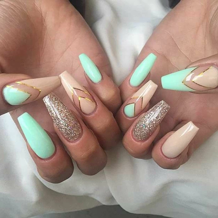 square or rectangular claw nails, decorated with pastel turquoise, and pale pastel pink nail polish, with golden glitter and details