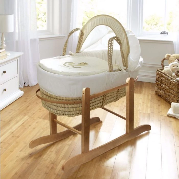 wicker baby basket, with rocking wooden feet, in pale beige, covered with white and ivory embroidered fabric, retro nursery ideas, light laminate floor