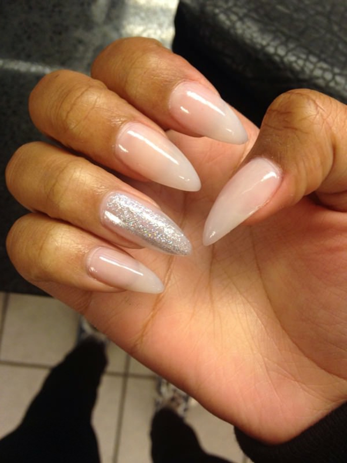 semi-sheer light pink nail polish, and silver glitter, on long oval nails, with sharp tips, simple and chic