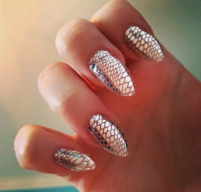 fish or snake skin scales, silver metallic and smooth, on long sharp nails, original and unusual idea