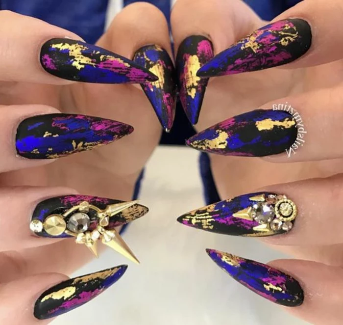 steampunk style nails, in black and dark electric blue, purple and gold, with sharp and chunky golden decorations, and rhinestone stickers