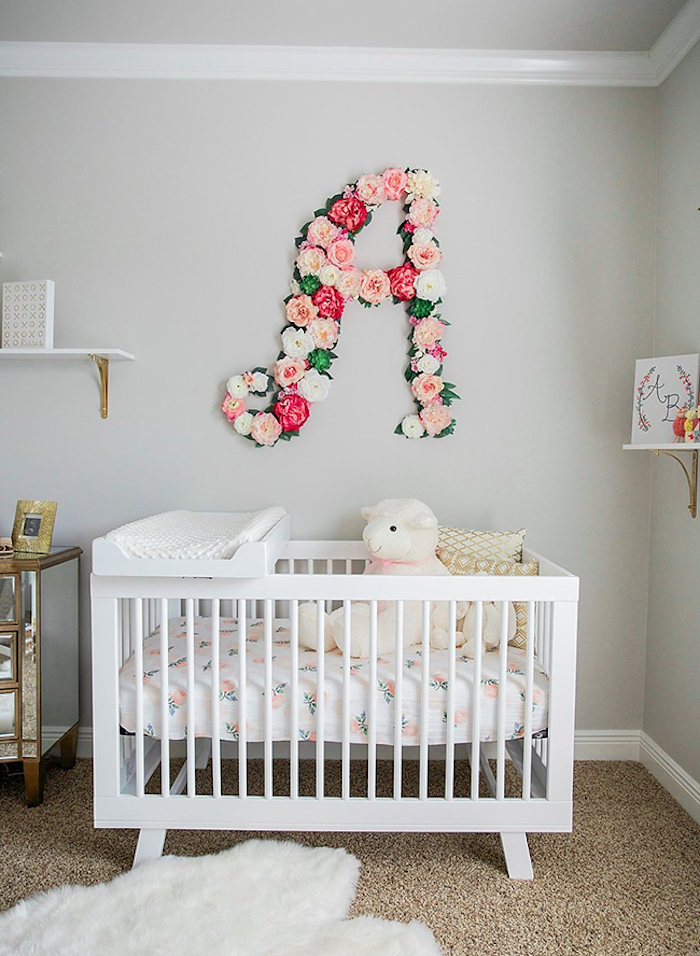 floral arrangement with white, light and dark pink faux roses, forming the latter a, over a white wooden crib, baby girl themes, floral bedding and stuffed sheep toy
