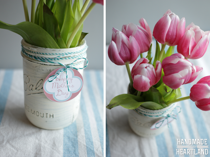 mason jar with white, hand-painted surface, label tied around with tread, mothers day presents, containing a bouquet, of pink and white tulips