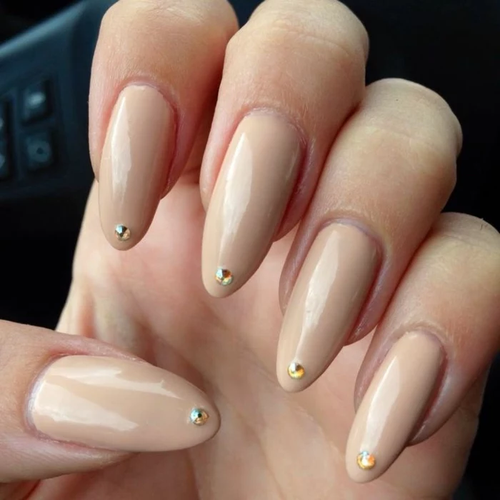 chic and very long, stiletto acrylic nails, with tiny and round, yellow rhinestone stickers