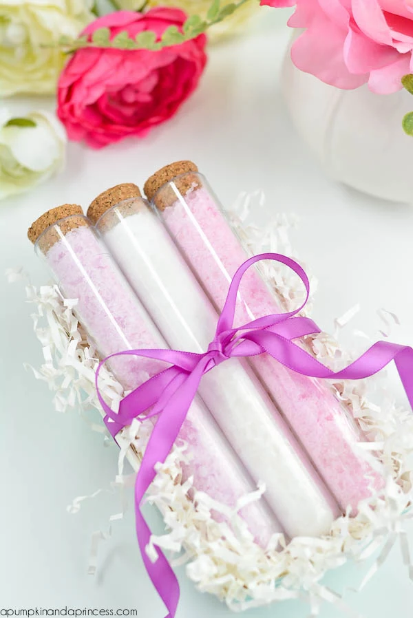bath salts in pale pink and white, inside three glass vials, tied with purple ribbon, with cork stoppers, mothers day presents