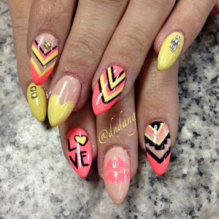 cheerful nails in yellow and beige, black and orange, decorated with different shapes, rhinestones and scribbles, stilleto nail designs 