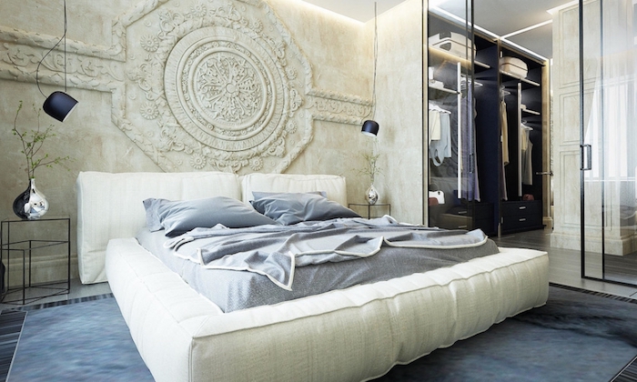 stone carving in ivory, near a soft white bed, bedroom wall decor, hanging lights and a walk-in wardrobe, with a glass door