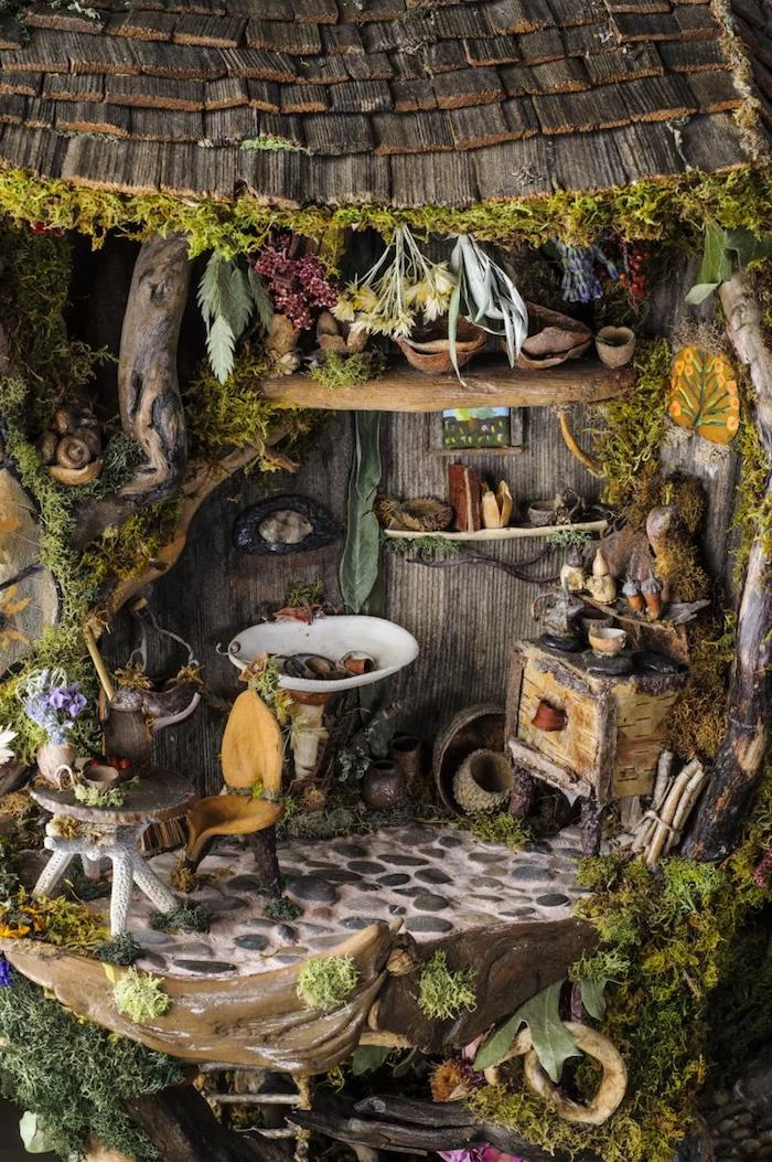 countryside style diy fairy house, with miniature shabby furniture, many tiny items, dried plants and flowers, moss and bark