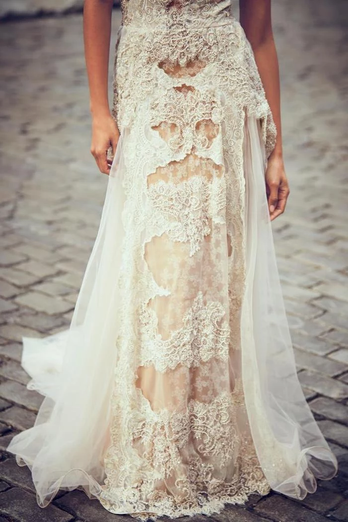 skirt in ivory and cream, floaty and heavily embroidered, part of a lace beach wedding dress, worn by slim female model
