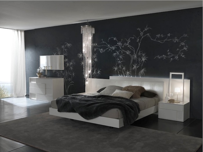 spacious dark bedroom, with black wall, decorated with white painted shapes, resembling bamboo plants, black tiled floor, dark gray carpet