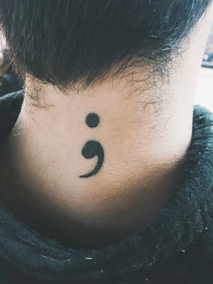 black bold semicolon tattoo, on the neck of a person, with short dark hair, wearing a black top, purpose of semicolon, symbolic tattoo ideas 