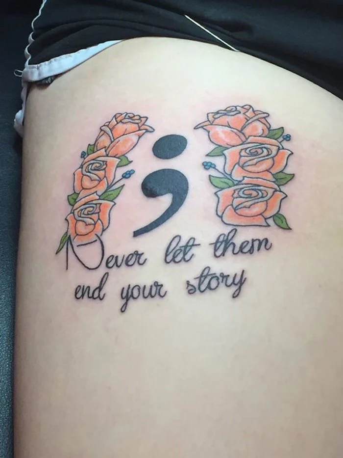 six orange roses with green leaves, near a large black semicolon project tattoo, on a person's upper leg, together with a message written in black