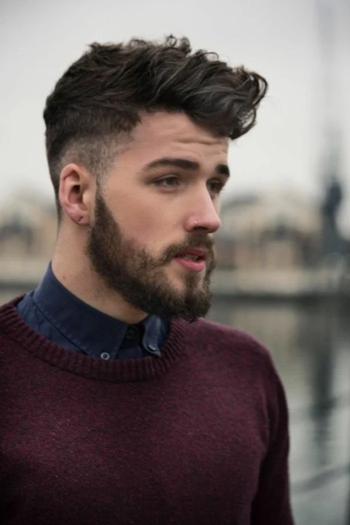 bearded man with purple knitted jumper, and dark denim shirt, hairstyles for curly hair, brunette undercut ideas