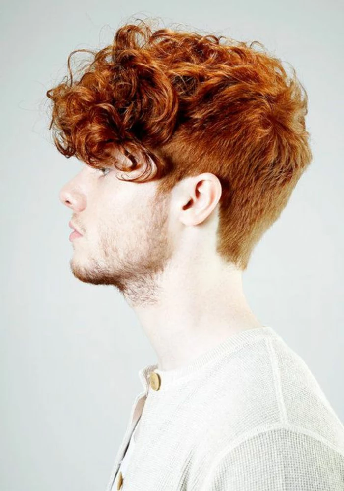 ginger haired youth, with short beard and mustache, wearing a curly quiff, with short sides and back, and long messy bangs