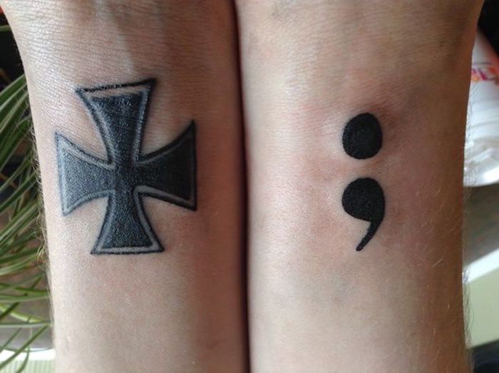 thick and bold cross tattoo, and fresh bold semicolon tattoo, both in black, on two arms, placed next to each other, semicolon tattoo on wrist, meaning and significance