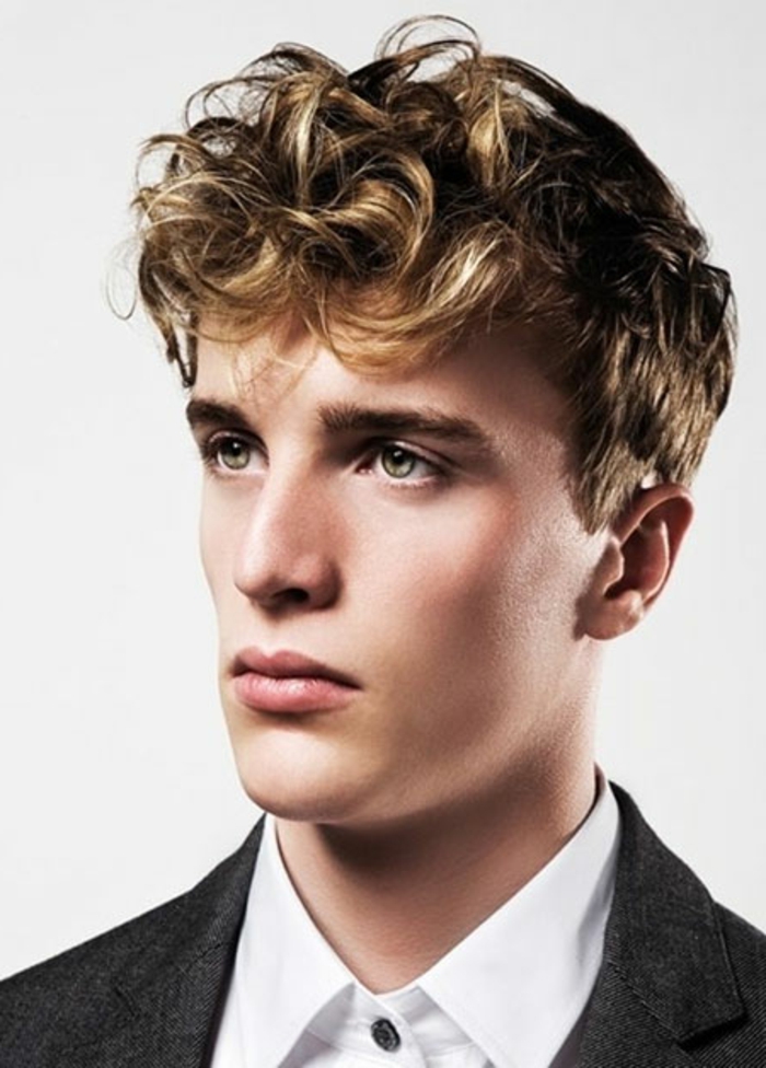 green-eyed young man, wearing a white shirt, and a dark gray blazer, curly haircuts, dirty dark blonde hair, styled in a quiff