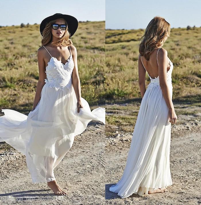 two photos showing a lace beach wedding dress, from two different angles, embroidered top and floaty skirt, worn by barefoot model, in sunglasses and hat