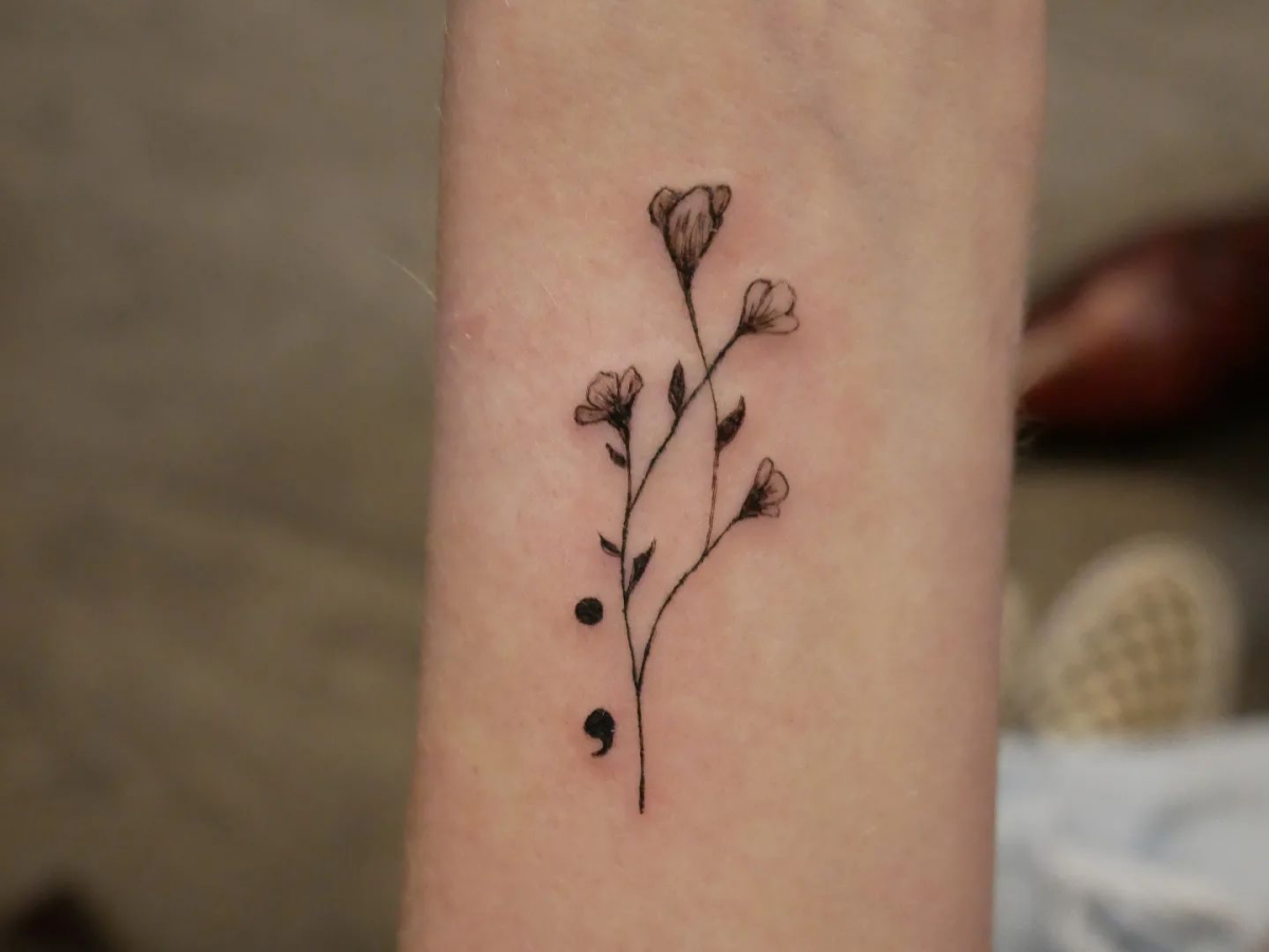 tattoo of flowers and a semicolon