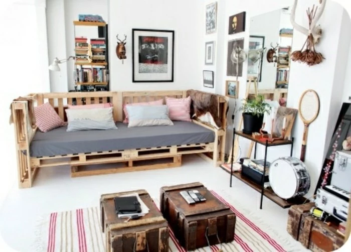 various vintage and retro items, inside a room with white floor and walls, containing a wooden bench, furniture made from pallets