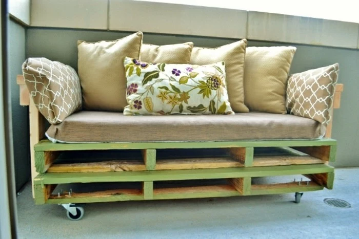 furniture made from pallets, light green wooden couch, covered with a large, beige couch cushion, and decorated with several smaller cushions