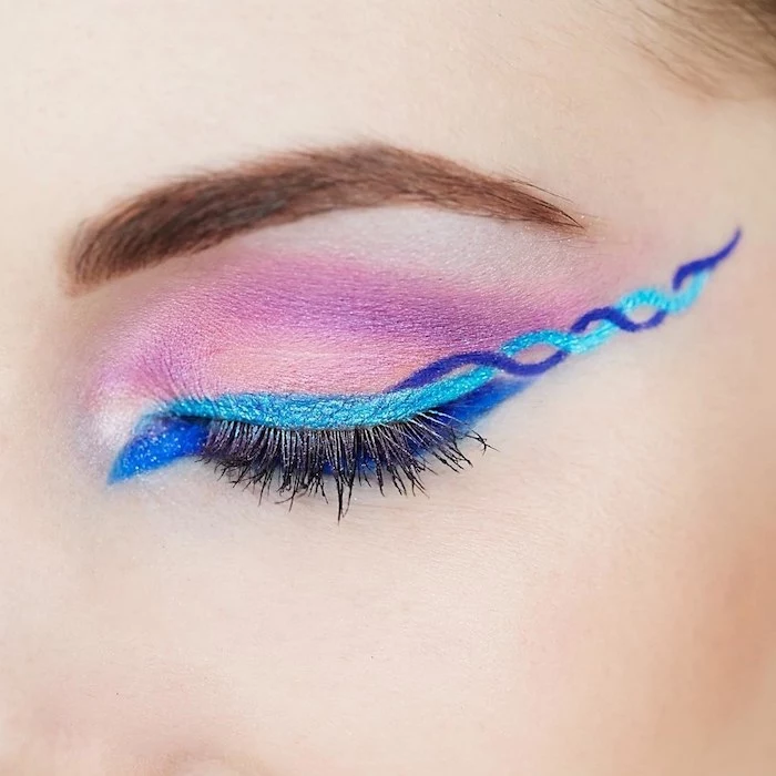 festival makeup, closed eye with pink eye shadow, pale blue and violet eyeliner, or eye pencil, in a swirly pattern