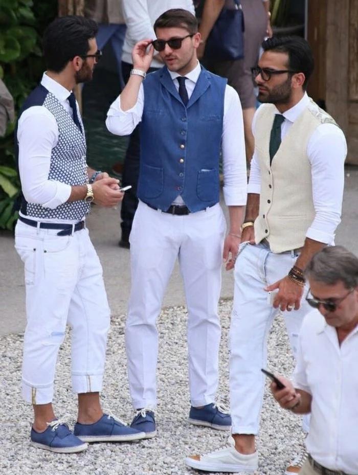 vests in different colors, white trousers and deck shoes in blue, mens casual summer wedding attire, worn by three young men, with glasses and ties