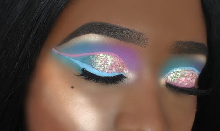 unicorn makeup, with iridescent glitter, and light pink and blue eyeshadow, fake lashes and light beige highlighter