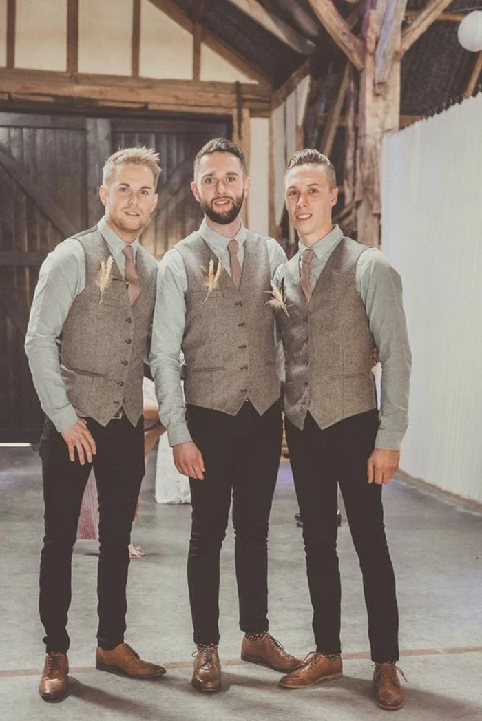 tweed formal vests in beige, worn by three men, standing next to each other, pale blue shirts, black trousers and brown shoes, boutonnieres and light ties, black tie optional wedding