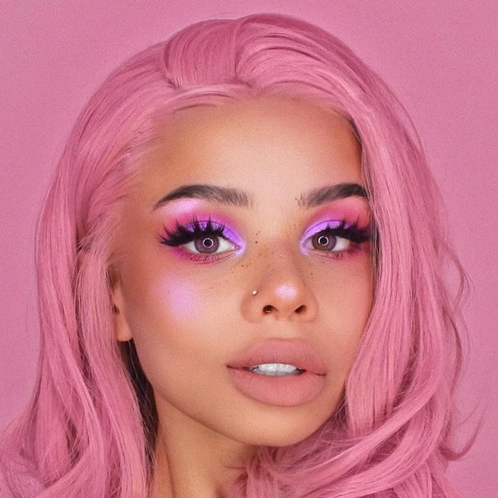 bubblegum pink hair, on girl with bronze skin, wearing eyeshadow in different shades of pink, and nude pink lipstick, festival makeup