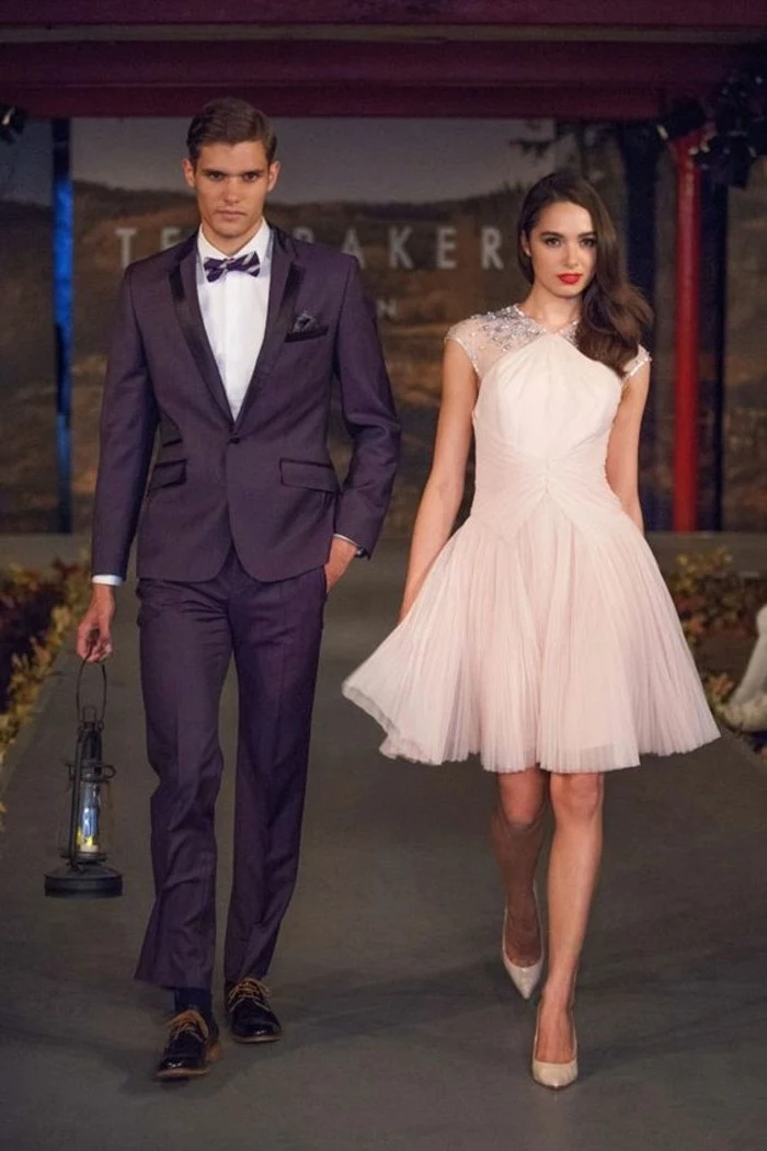 floaty pale pink dress, with tulle skirt and sequin details, worn b y brunette woman, walking next to man in black tuxedo, mens summer wedding attire, white shirt and bowtie