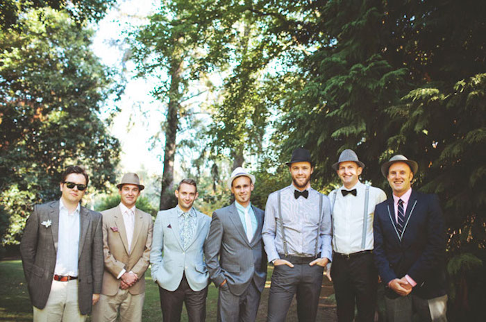 seven men in casually elegant clothes, what is semi formal attire, blazers and shirts, suspenders and bow ties, hats and sunglasses