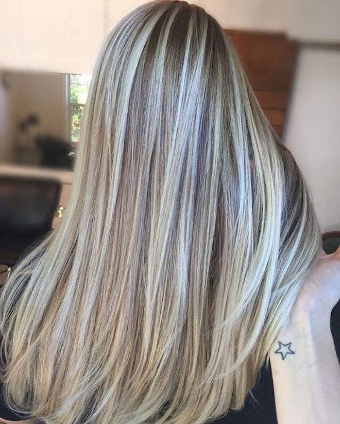 platinum blonde highlights, on long brunette hair, straightened and smooth, brown and blonde hair, hand holding several strands