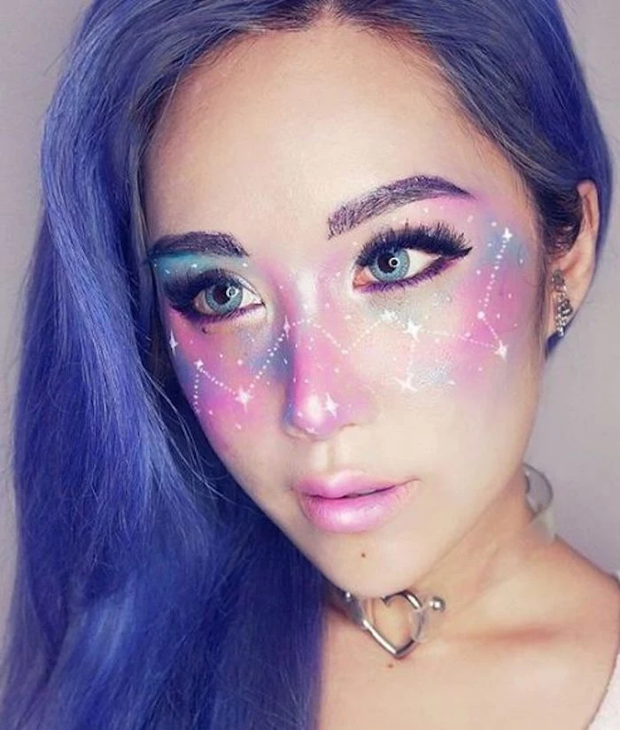 cute makeup looks, or body art ideas, space painted in pink and blue, with constellations and stars in white, on the face of a young girl, with pearly pink lipstick, and violet hair