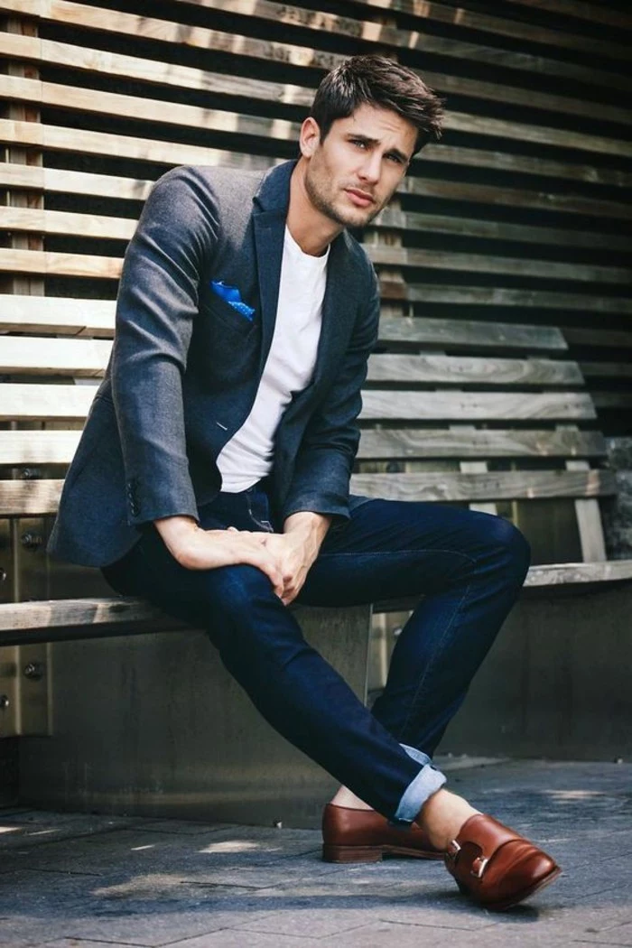 jeans in dark blue, worn with white t-shirt, and dark bluish-grey blazer, with blue pocket handkerchief, what is cocktail attire for men, brunette man wearing brown leather shoes 