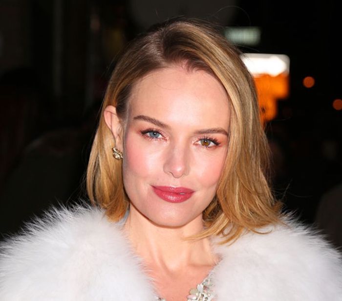 smooth hair with side part, worn tucked behind one ear, and falling over the other, easy short hairstyles, smiling woman in a fluffy, white fur coat