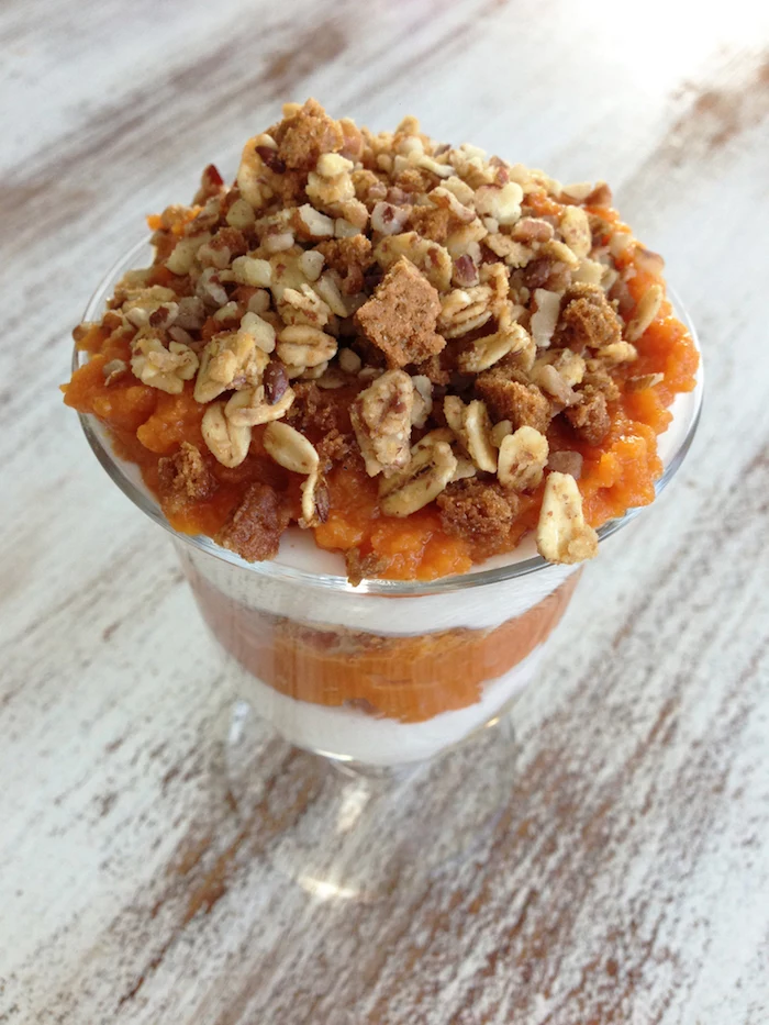 parfait made from yoghurt and pumpkin, topped with rolled oats, and crunchy granola, easy breakfast recipes, and put in a sundae glass