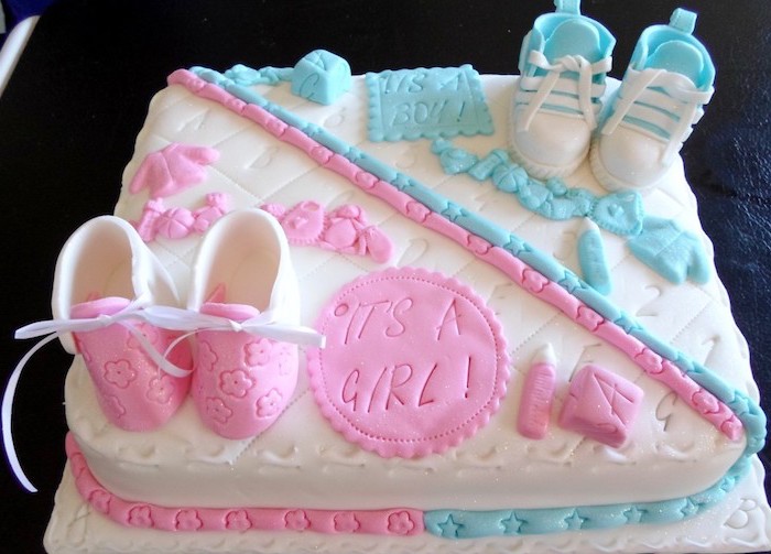 baby shower sheet cakes, a rectangular white cake, divided into two halves, one decorated with pink shoes and other items, and the other with bluer sneakers and items