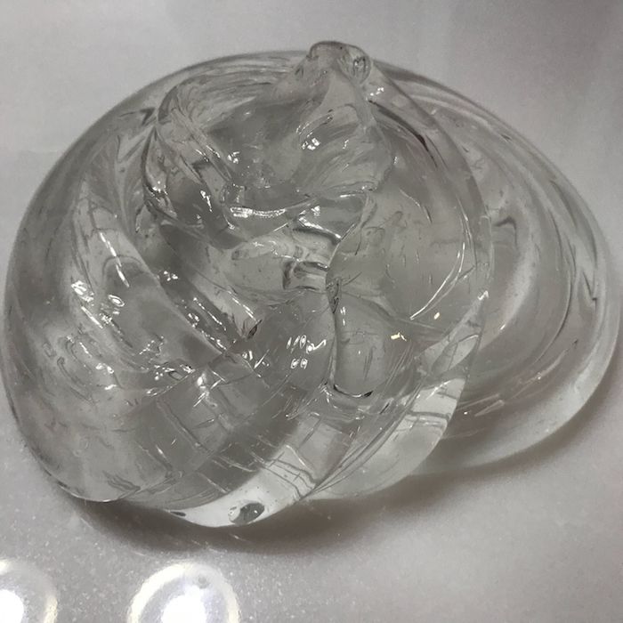transparent slimy goo, in a twisted pile, shaped into a roundish form, how to make slime with borax, on a smooth, and flat surface