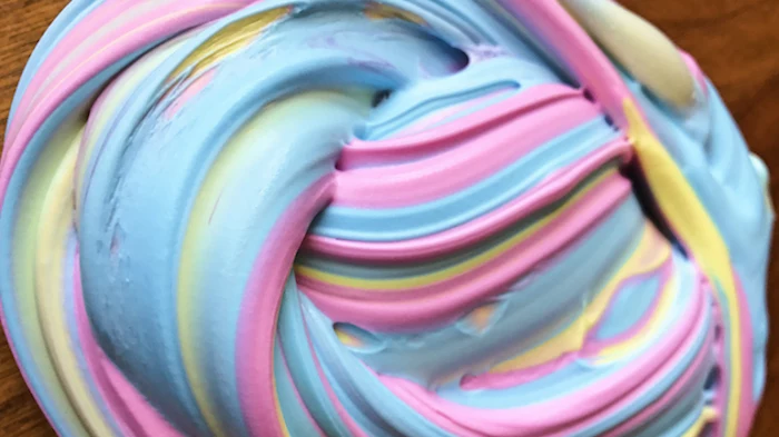 how to make fluffy slime, a twisted pile of multicolored goo, in pastel pink, baby blue and pale yellow, seen in close up