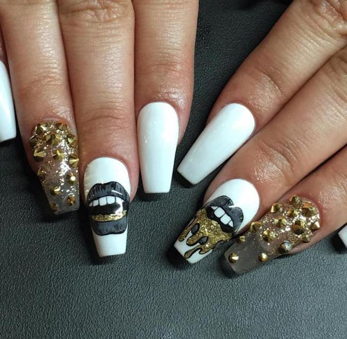 drawings of lips in grey and gold, on the middle finger nails of two hands, the rest of the coffin acrylic nails are pure white, or clear and covered with gold rhinestones