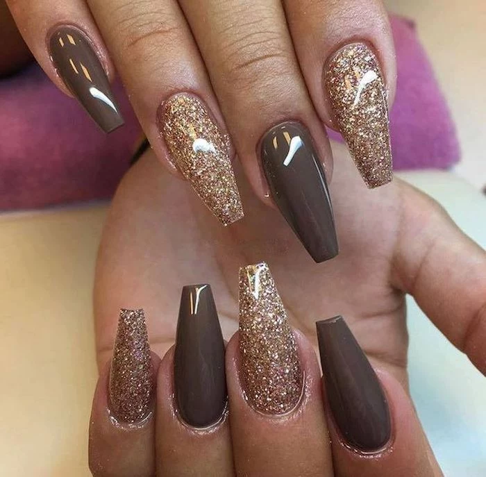 coffin nail designs, smooth dark beige, and rose gold-colored nail polish, with fine glitter, on the eight visible fingers, of two hands
