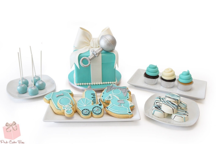 turquoise and white cake, shaped like a present with a fondant bow, cookies shaped like various baby-related items, baby shower cakes for boys, cupcakes and cake pops