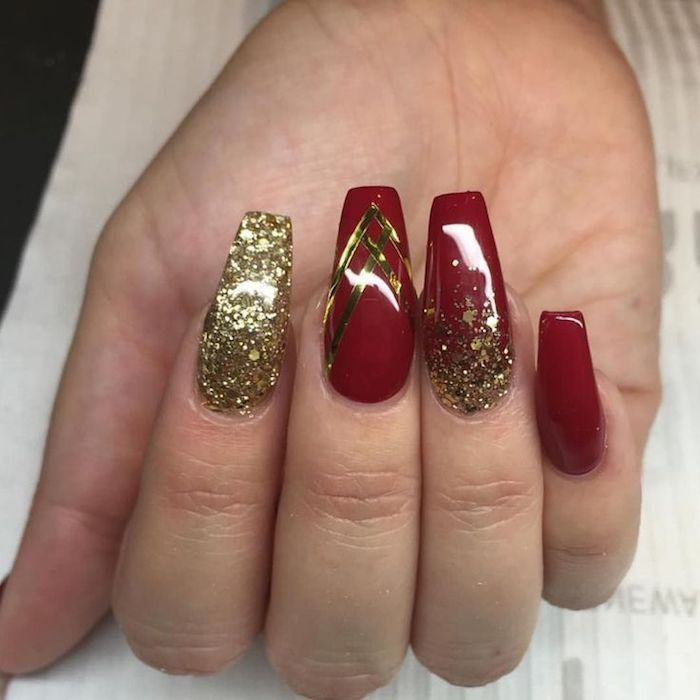 sparkling gold glitter, and four gold stripes, coffin nail designs, on a hand with smooth and shiny, deep red nail polish