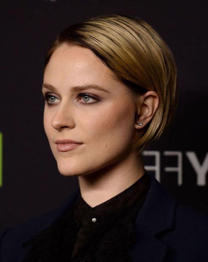 slicked blonde bob, with dark roots, tucked behind the ear, worn by evan rachel wood, hairstyles for women with thin hair, in a black shirt, and wearing discrete make up