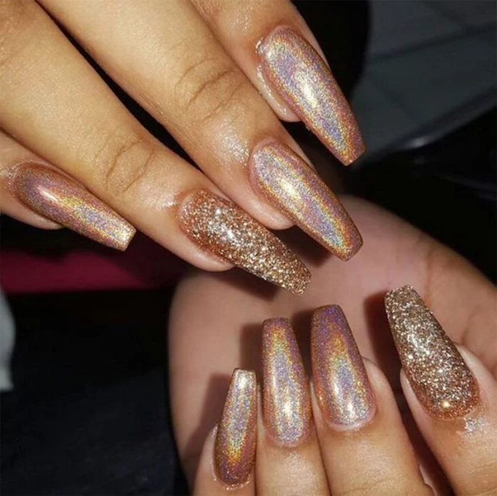 glistening long nude coffin nails, with iridescent effect, two of the nails are covered in rough, glitter flakes in gold