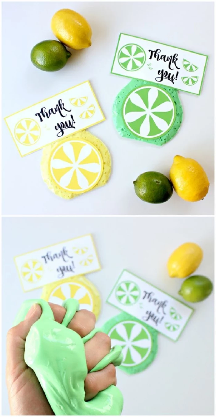 lemons and limes, and two thank you notes, in yellow and green, placed near two round pieces of slime, decorated like citrus fruit, hand squeezing fluffy green slime