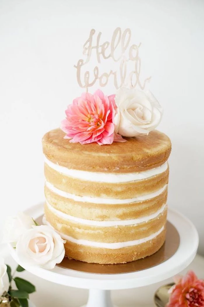 hello world written in white, baby shower cake toppers girl, on top of a five-layered cake, decorated with fresh flowers, in pink and white