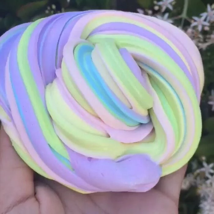 foamy multicolored twisted piece of goo, in soft pastel colors, how to make fluffy slime, pale yellow and green, baby blue and pink, with light purple