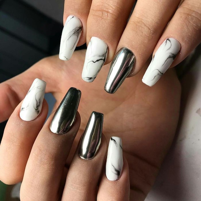 marble pattern in white and grey, and smooth silver metallic effect, on the coffin nails of two hands, with folded fingers
